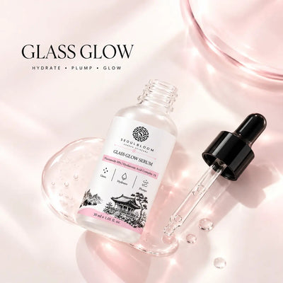Seoul Bloom Glass Glow Serum in a clear glass bottle with a dropper, featuring pink accents and a minimalist design.